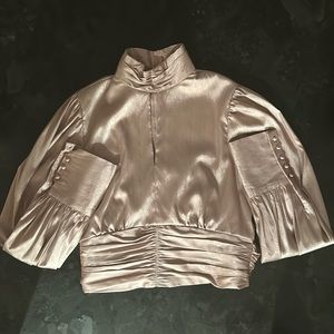 This is a INA long sleeve shirt. It is a size medium and it is a light pink